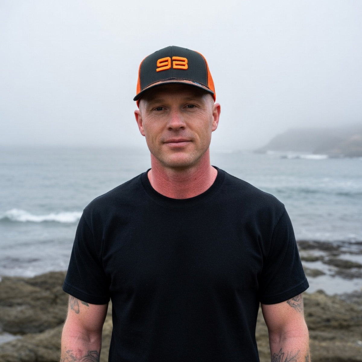 9B trucker hat worn on the Santa Cruz coast, orange and charcoal foam-front cap.