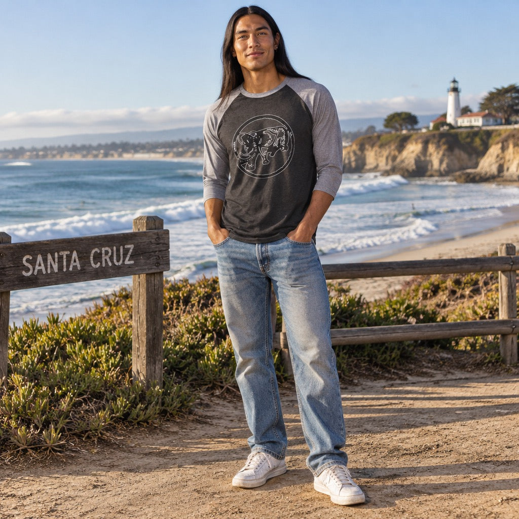 Man in a grey and black 9BARN raglan tee on the Santa Cruz coast