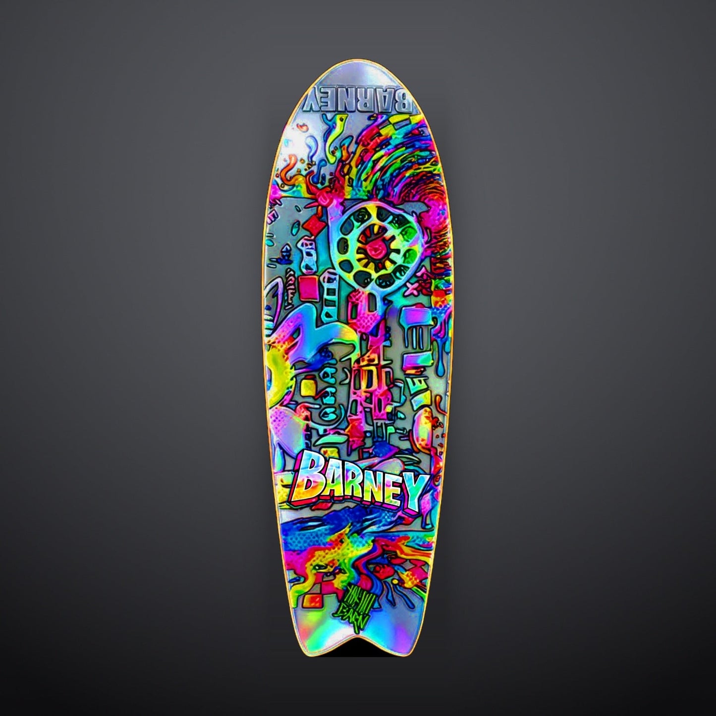 9BARN skate deck, Kaleidoscope. Iridescent swallowtail deck covered in dots and circles, BARNEY in rainbow block letters across the middle and flipped at the nose.